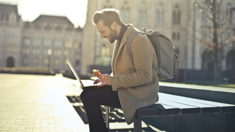 A man sits with his laptop in Budapest, Hungary. (Pexels)