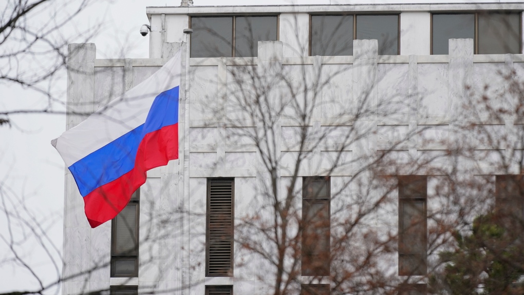 The Russian flag flies outside the Embassy of Russia in Washington, Thursday, Feb. 24, 2022. (AP Photo/Patrick Semansky)