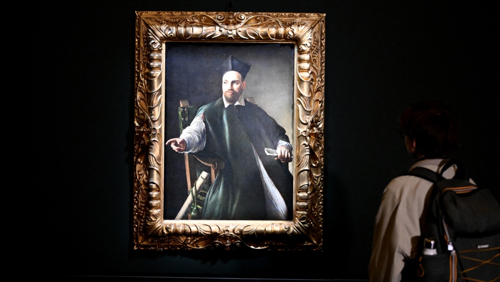 A visitor looks at the Maffeo Barberini portrait by Caravaggio at the Gallerie Nazionali di Arte Antica in the Palazzo Barberini in Rome on November 22, 2024. (Photo by Alberto PIZZOLI / AFP)