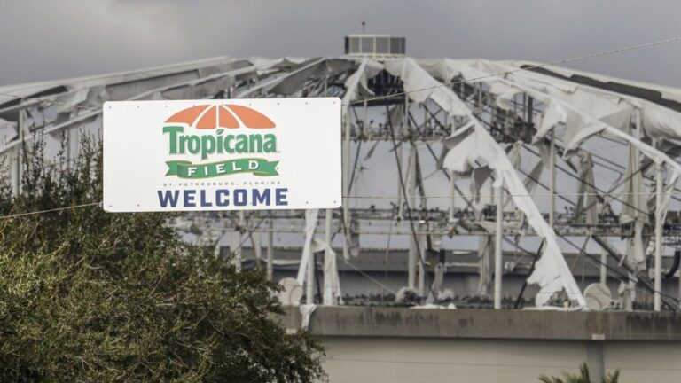 Signage at the entrance to the parking lot of Tropicana Field where the roof was torn off during Hurricane Milton on Thursday, Oct. 10, 2024, in St. Petersburg, Fla. (AP Photo/Mike Carlson, File)