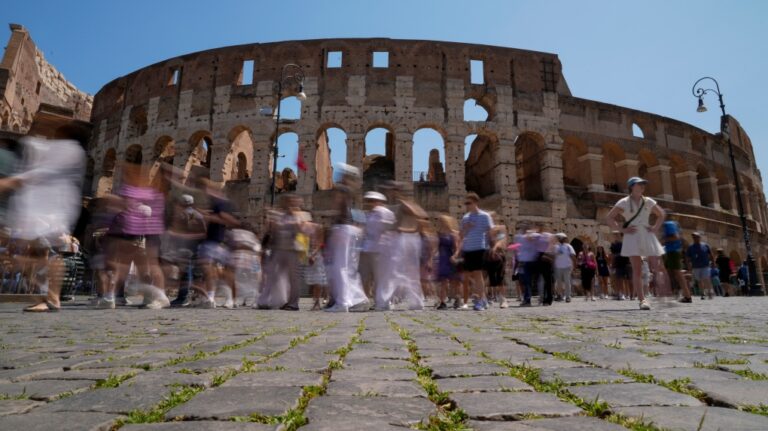 Visitors walk past the Colosseum, in Rome, Tuesday, June 27, 2023. (AP Photo/Andrew Medichini)