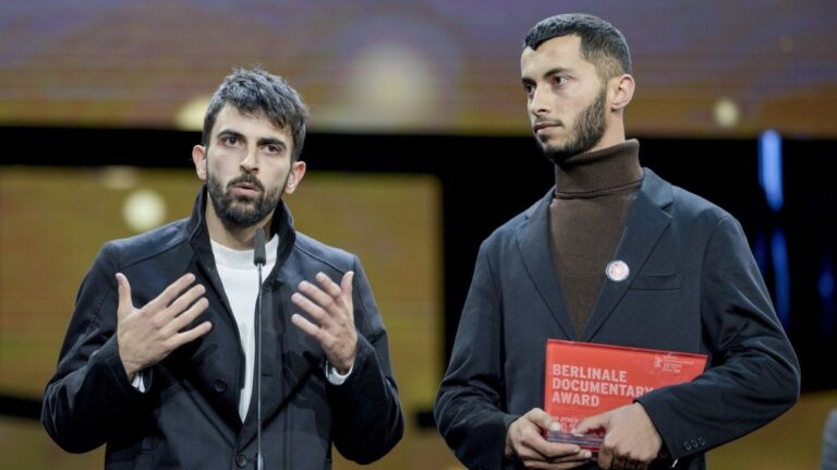 Palestinian Basel Adra, right, and Israeli Yuval Abraham receive the documentary award for "No Other Land" at the International Film Festival, Berlinale, in Berlin, Saturday, Feb. 24, 2024. (AP Photo/Markus Schreiber)