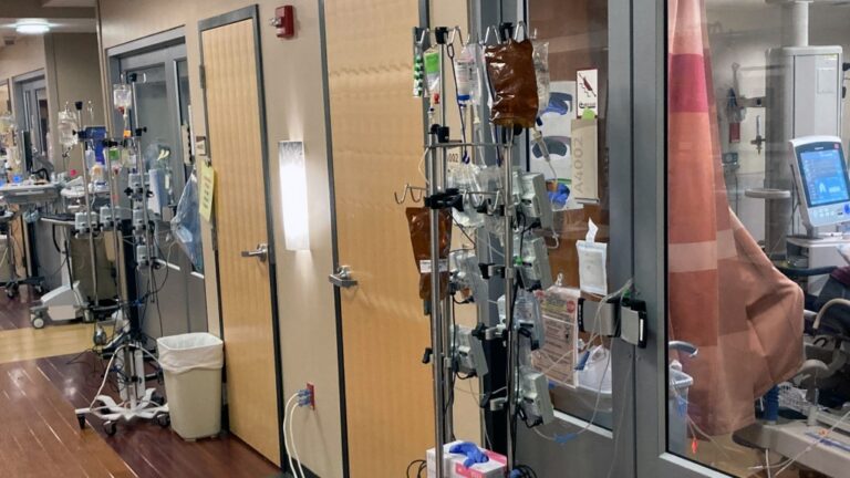IV poles and IV bags are seen in the hallway of a U.S. hospital in August 2021. (AP Photo/Andrew Selsky)