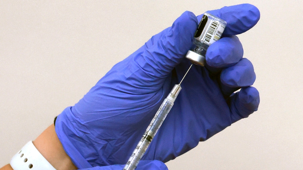 ACVS pharmacist prepares to administer a shot of Comirnaty, the new Pfizer/BioNTech vaccination booster for COVID-19, at the Baldwin Park store on New Broad Street in Orlando, Fla., Friday, Sept. 15, 2023. (Joe Burbank/Orlando Sentinel via AP)