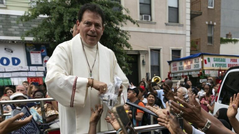 Former pastor of Shrine Church of Our Lady of Mount Carmel Monsignor Jamie Gigantiello speaks with parishioners, July 16, 2022, in the Brooklyn borough of New York. (AP Photo/Julia Demaree Nikhinson)
