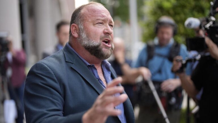 Right-wing conspiracy theorist Alex Jones speaks to the media after arriving at the federal courthouse for a hearing in front of a bankruptcy judge, Friday, June 14, 2024, in Houston. (AP Photo/David J. Phillip)
