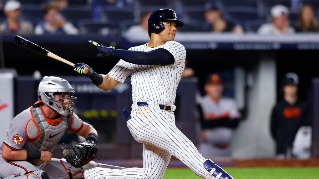 New York Yankees' Juan Soto, right, follows through on single during the sixth inning of a baseball game against the Baltimore Orioles, Sept. 26, 2024, in New York. (AP Photo/Noah K. Murray)
