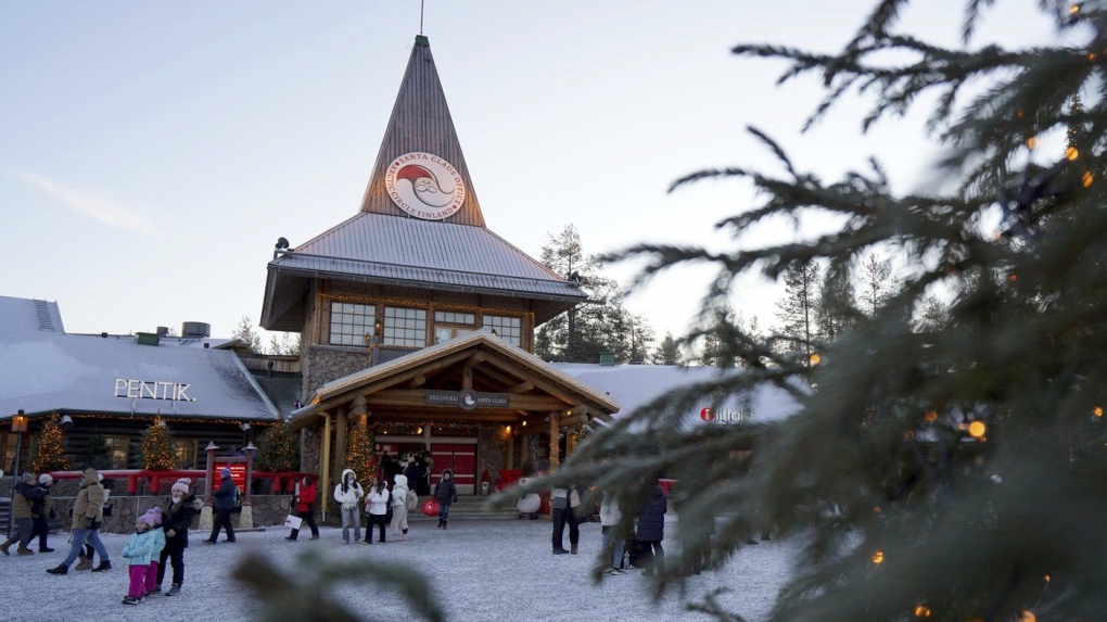 Tourists gathered at Santa Claus Village, a winter-themed amusement park perched on the edge of the Arctic Circle, in Rovaniemi, Finland, Wednesday, Dec. 4, 2024. (AP Photo/James Brooks)