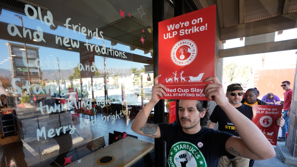 Starbucks workers picket outside of a closed Starbucks, Dec. 20, 2024, in Burbank, Calif. (AP Photo/Damian Dovarganes)