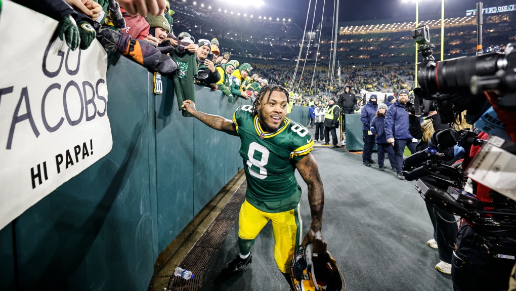 Green Bay Packers running back Josh Jacobs (8) greets fans after an NFL football game against the New Orleans Saints, Dec. 23, 2024, in Green Bay, Wis. (AP Photo/Jeffrey Phelps