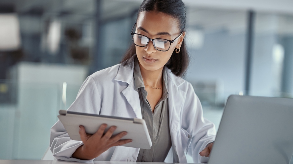 Stock photo of a doctor using a digital tablet at work. (Getty Images / Marco VDM)