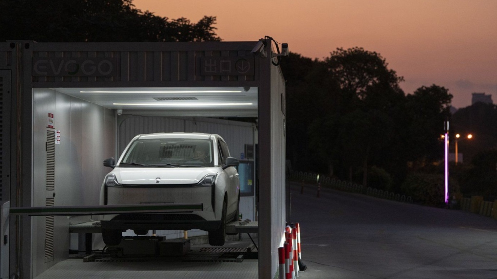 A driver gets his car battery swapped at a first generation station by China-based CATL battery manufacturing company, in Xiamen, Fujian province, China, Wednesday, Dec. 18, 2024. (AP Photo/Ng Han Guan)