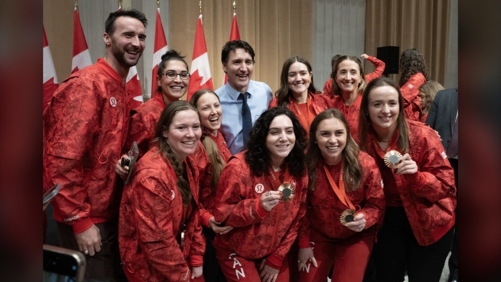 Prime Minister Justin Trudeau poses for a photo with Olympians and Paralympians during an event in the Parliamentary precinct, in Ottawa, Wednesday, Dec. 4, 2024. (THE CANADIAN PRESS/Adrian Wyld)