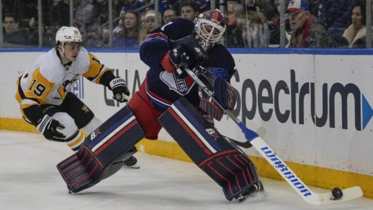 New York Rangers goaltender Igor Shesterkin passes to a teammate as Cody Glass closes in during an NHL hockey game Friday, Dec. 6, 2024, in New York. (AP Photo/Frank Franklin II)