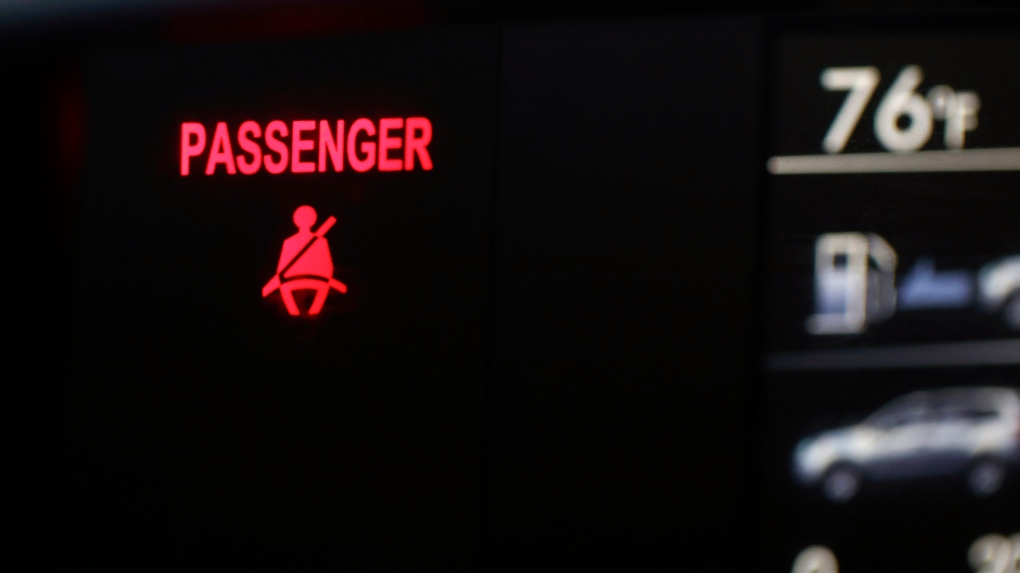 A seat belt warning sign is displayed in a vehicle on Aug. 21, 2023. (Jenny Kane / AP Photo)