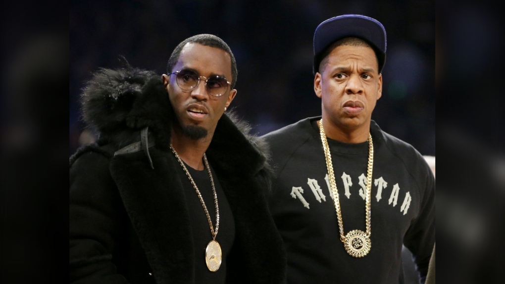 Rap moguls Sean "Diddy" Combs, left, and Jay-Z attend the NBA All-Star basketball game, Feb. 15, 2015, in New York. (AP Photo/Kathy Willen)