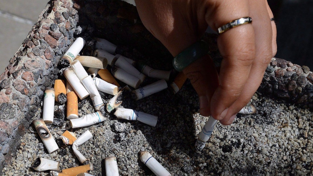 A smoker puts out a cigarette in a public ash tray in Ottawa on May 31, 2016. THE CANADIAN PRESS/Sean Kilpatrick