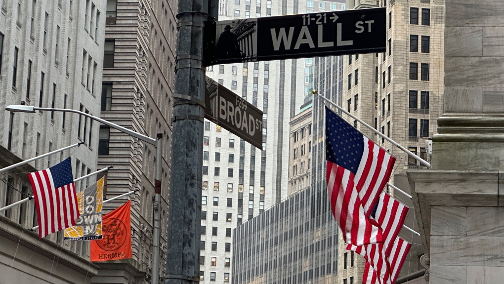 American flags hang from the front the New York Stock Exchange, right, on April 11, 2024 in New York. (Peter Morgan / The Associated Press)