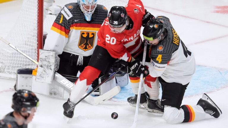 Canada forward Ethan Gauthier tries to deflect the puck past Germany goaltender Nico Pertuch as he is pressured by defenceman Max Hense during second period IIHF World Junior Hockey Championship tournament action in Ottawa, Dec. 29, 2024. THE CANADIAN PRESS/Adrian Wyld
