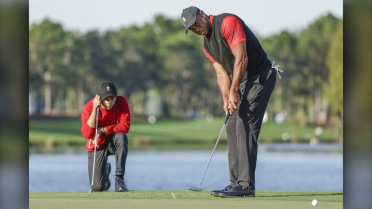 Charlie Woods watches his father Tiger Woods during the final round of the PNC Championship golf tournament, Dec. 18, 2022, in Orlando, Fla. (AP Photo/Kevin Kolczynski)