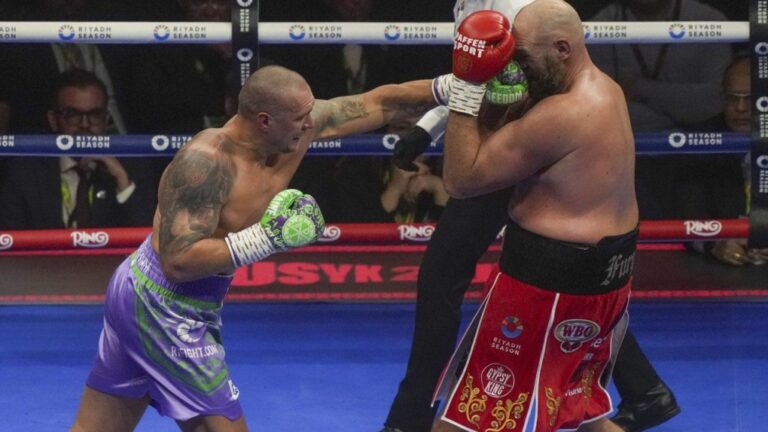 Boxers Britain's Tyson Fury, right, and Ukraine's Oleksandr Usyk compete during their WBA, WBO, and WBC world heavyweight title fight in Riyadh, Saudi Arabia, Saturday, Dec. 21, 2024. (Frank Augstein/AP Photo)