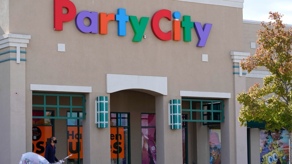 A shopper leaves a Party City store in Vernon Hills, Ill., Oct. 15, 2020. (AP Photo/Nam Y. Huh)