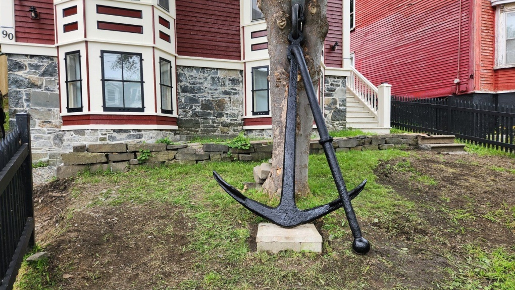 A historic, 400-kilogram anchor that was dragged up from the bottom of the ocean off of Newfoundland’s Cape St. Mary’s bay sits propped up against a tree in front of Tyler Stapleton’s house in an undated handout photo. THE CANADIAN PRESS/HO-Tyler Stapleton