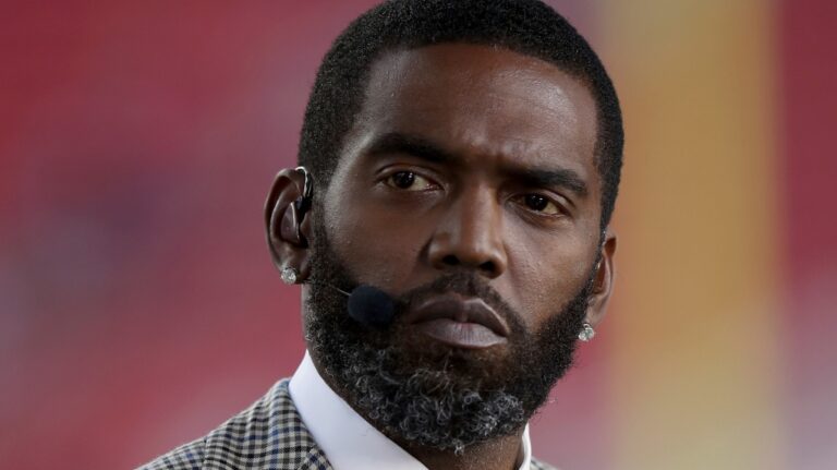 Broadcaster Randy Moss sits on the sideline before an NFL football game between the San Francisco 49ers and the Los Angeles Rams, Monday, Nov. 15, 2021, in Santa Clara, Calif. (AP Photo/Scot Tucker, File)