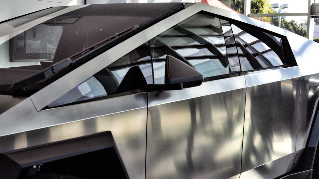 A Tesla Cybertruck is on display at Tesla in Buena Park, Calif. on Sunday Dec. 3, 2023. With manufacturing kinks still to be worked out, Tesla has delivered the first dozen or so of its futuristic Cybertruck pickups to customers. (AP Photo/Richard Vogel, File)