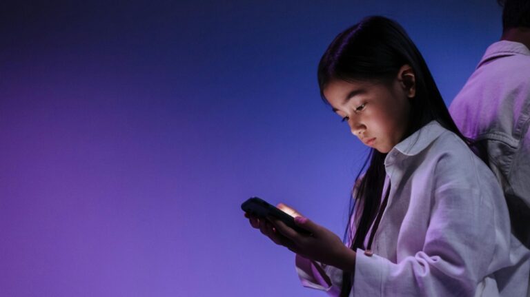 A young girl is seen using a phone in this undated file image. (Ron Lach via Pexels)
