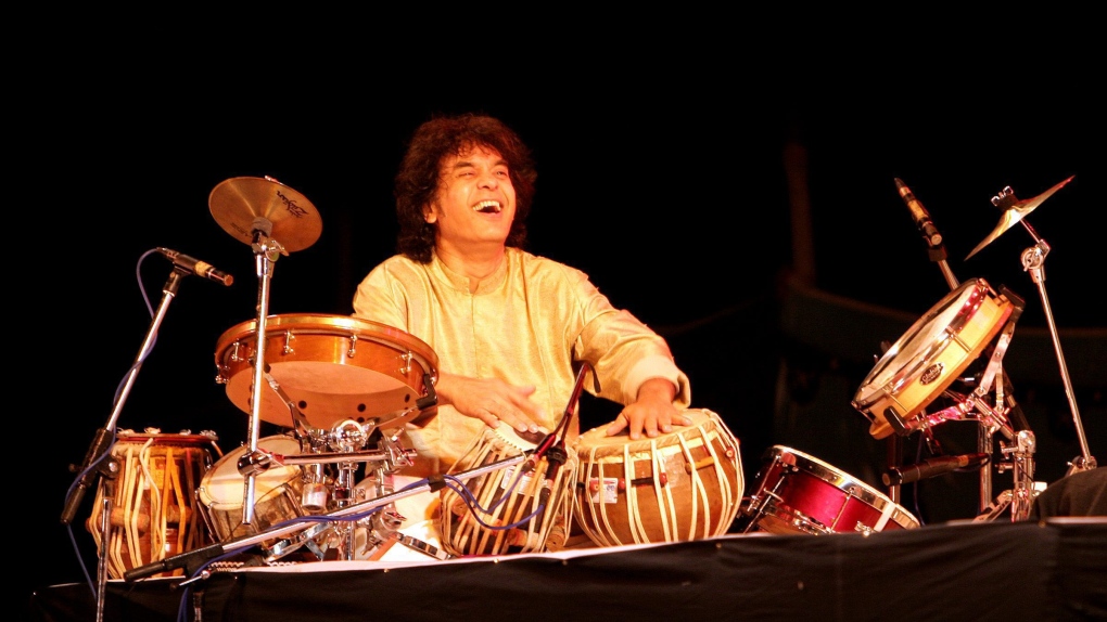 Indian tabla maestro Zakir Hussain performs during a musical concert in Bangalore, India, Dec. 13, 2006. (AP Photo/Aijaz Rahi)