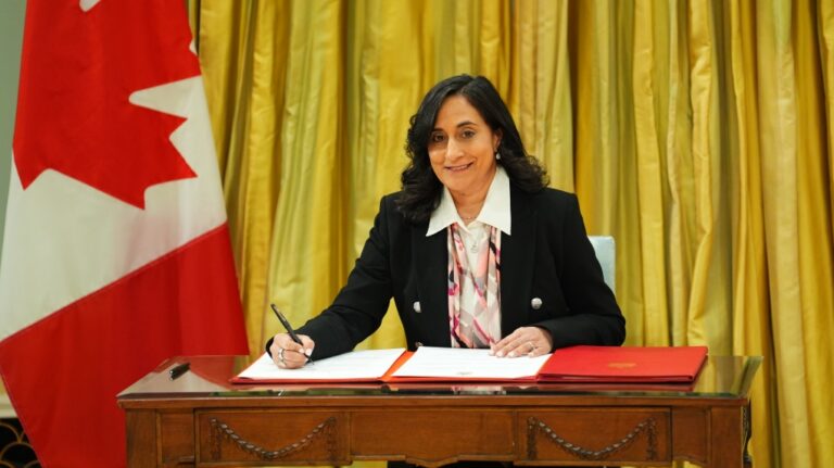 Transport Minister Anita Anand signs a document during a cabinet swearing-in ceremony at Rideau Hall in Ottawa, on Friday, Dec.20, 2024. THE CANADIAN PRESS/Sean Kilpatrick