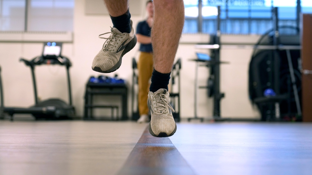 Jacob Bullard leaps in the air as part of a physical therapy exercise at WashU, Dec. 16, 2024, in St. Louis. (AP Photo/Jeff Roberson)
