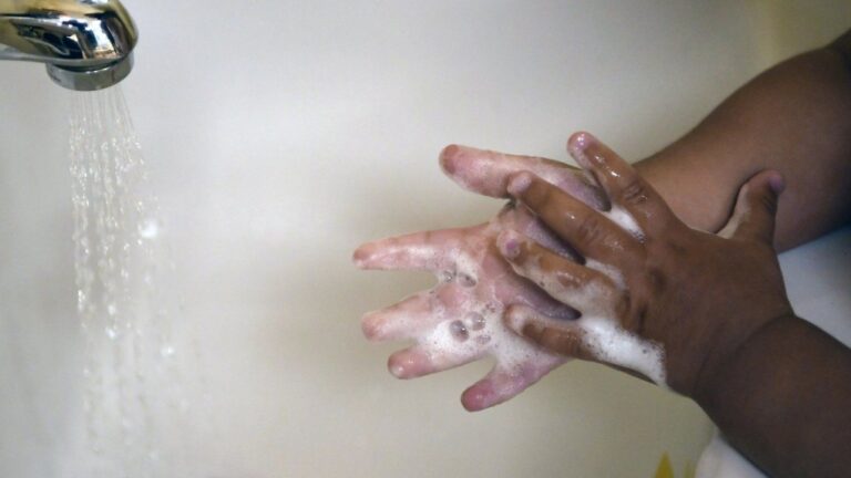 A child washes her hands at a day care center in Connecticut on Thursday Aug. 27, 2020. (AP Photo/Jessica Hill, File)