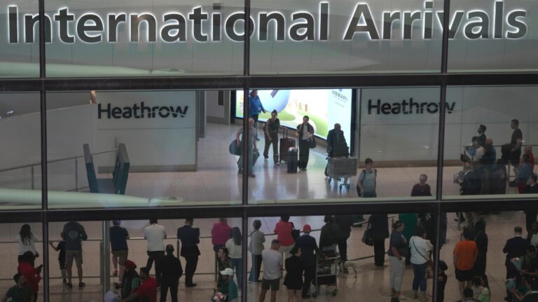 Passengers arrive at the Heathrow Airport, in London Saturday, May 27, 2023. Passengers flying into the UK are facing delays at passport controls due to the e-gates are not working. (AP Photo/Kin Cheung)