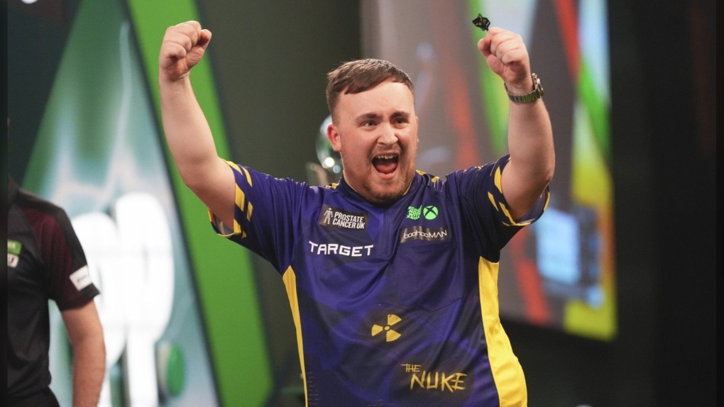 Luke Littler of England celebrates after winning the final against Michael van Gerwen of the Netherlands at the World Darts Championship at Alexandra Palace in London, Friday, Jan. 3, 2025. (AP Photo/Kirsty Wigglesworth)