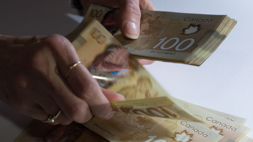 Canadian $100 bills are counted in Toronto, Feb. 2, 2016. THE CANADIAN PRESS/Graeme Roy